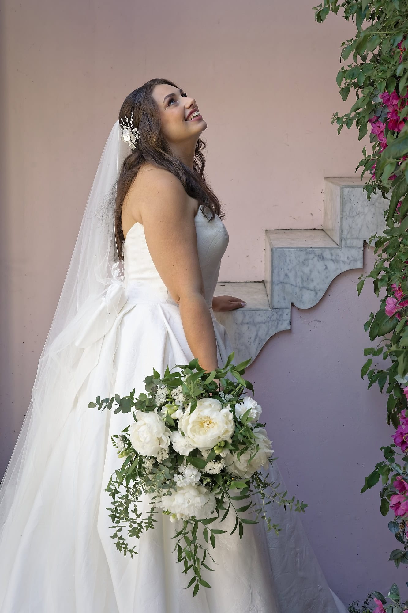 Bride looking up at groom on the balcony above the Moroccan Courtyard