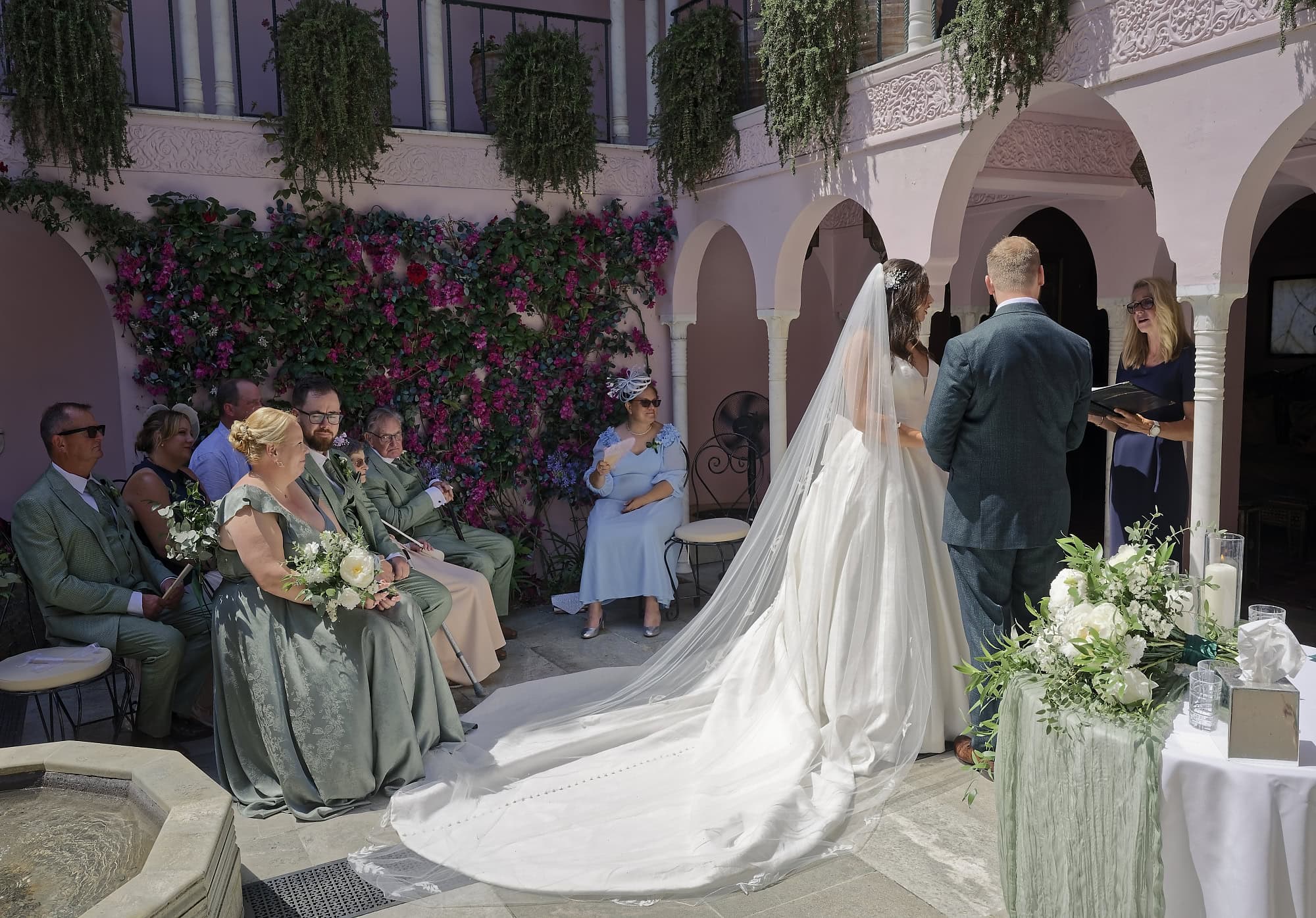 Wide view of the wedding ceremony in the Moroccan Courtyard as the officiant reads