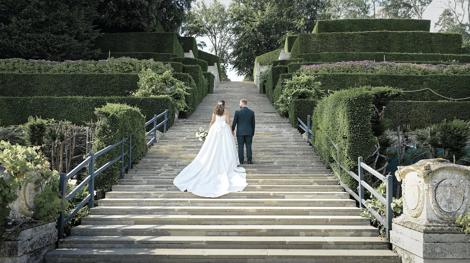 Bride and groom on the grand steps in golden evening light