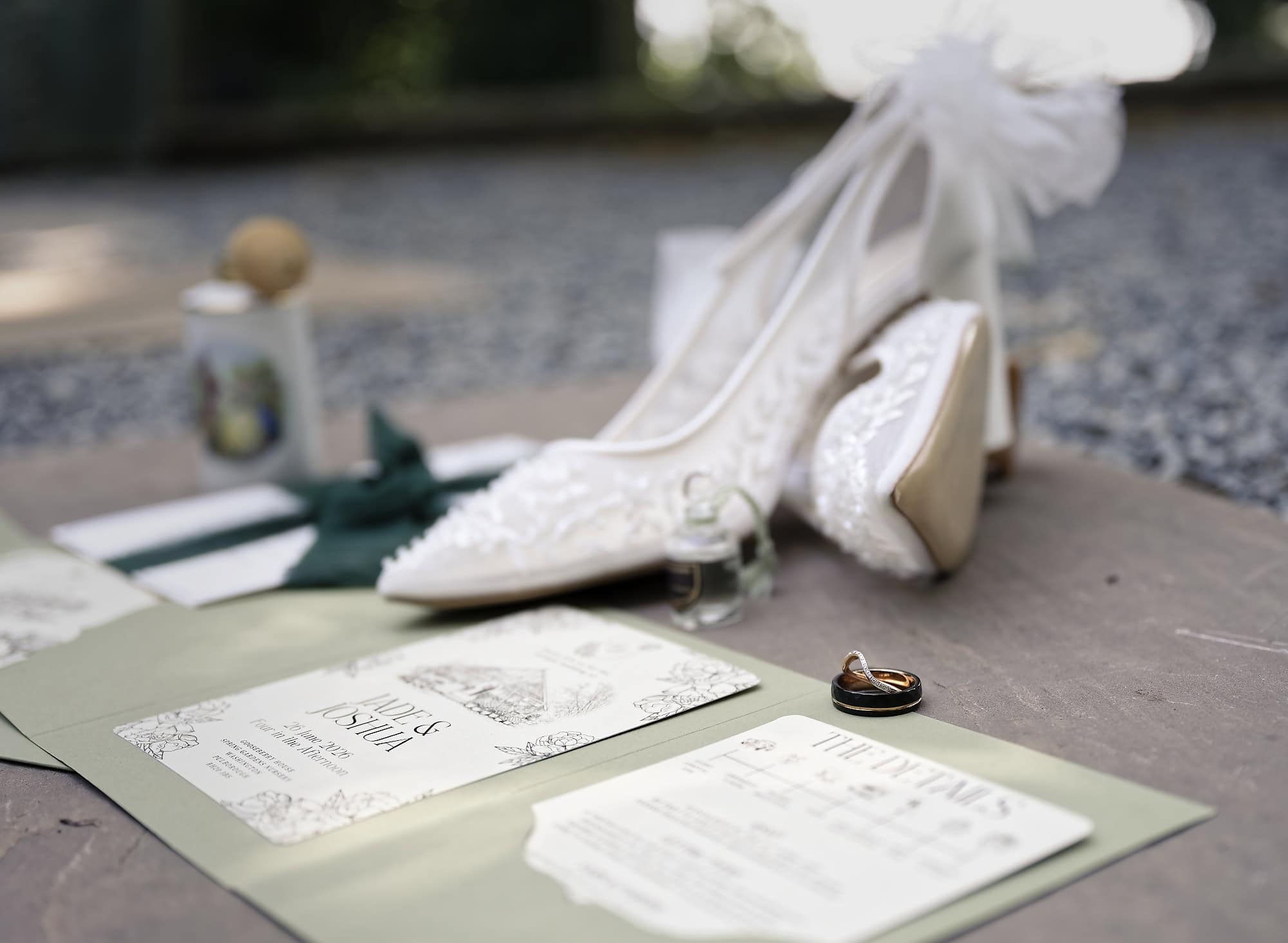 Wedding shoes, rings and stationery detail flat lay for Jade and Josh's wedding