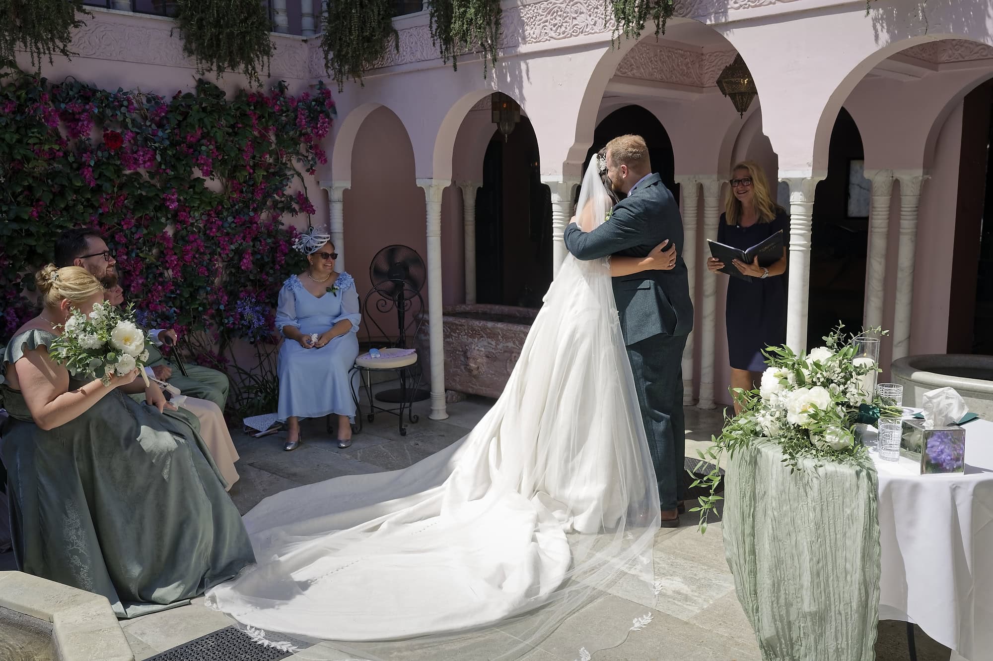 Bride and groom share a hug during their wedding ceremony in the Moroccan Courtyard