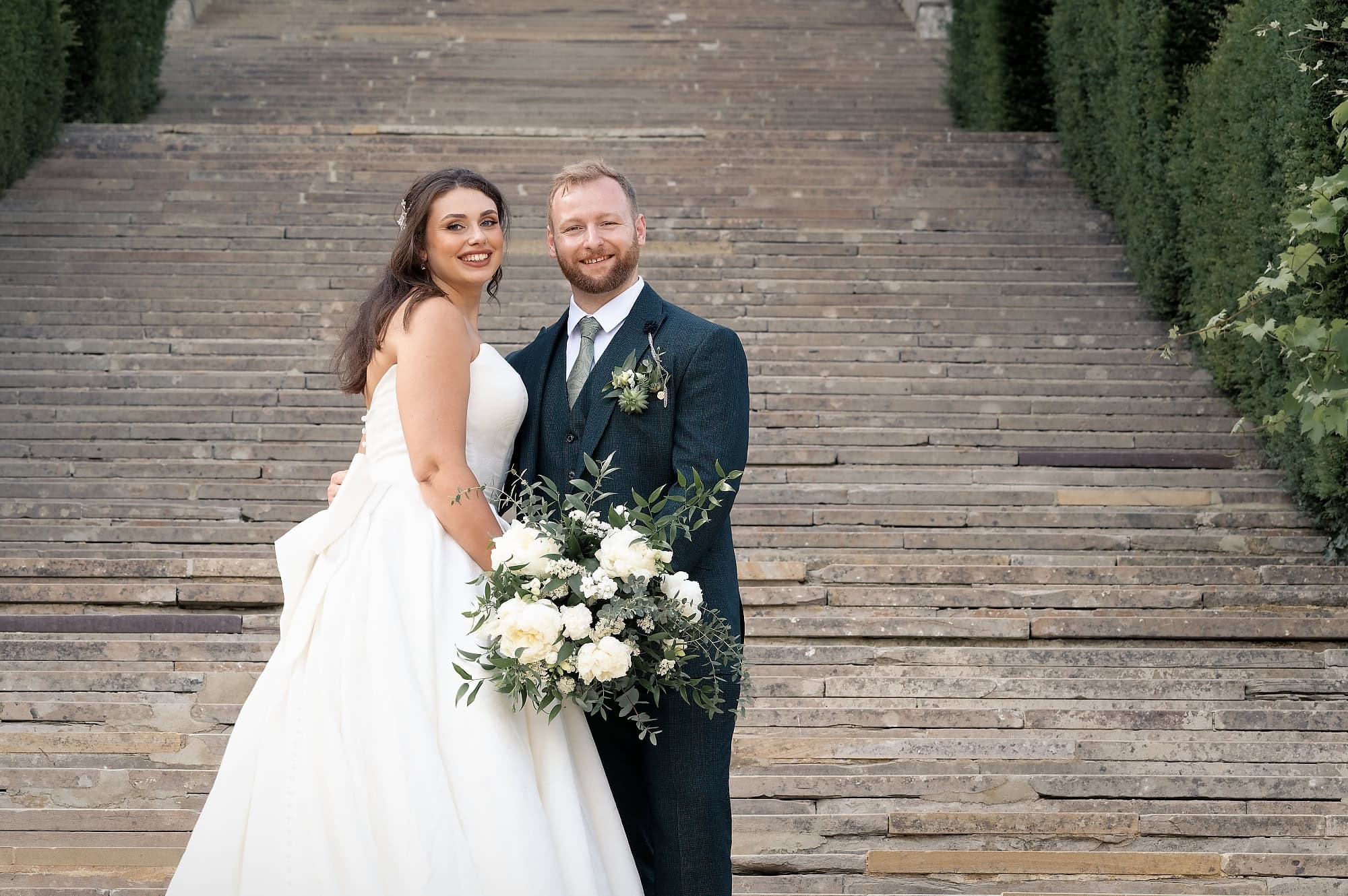 Port Lympne wedding photographer's portrait of the couple on the grand steps