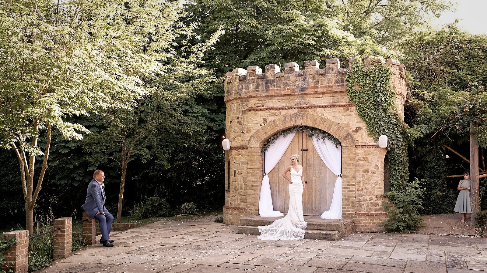 Bride in front of the Little Castle at The Ravenswood smiling at her groom in a quiet moment in the evening light