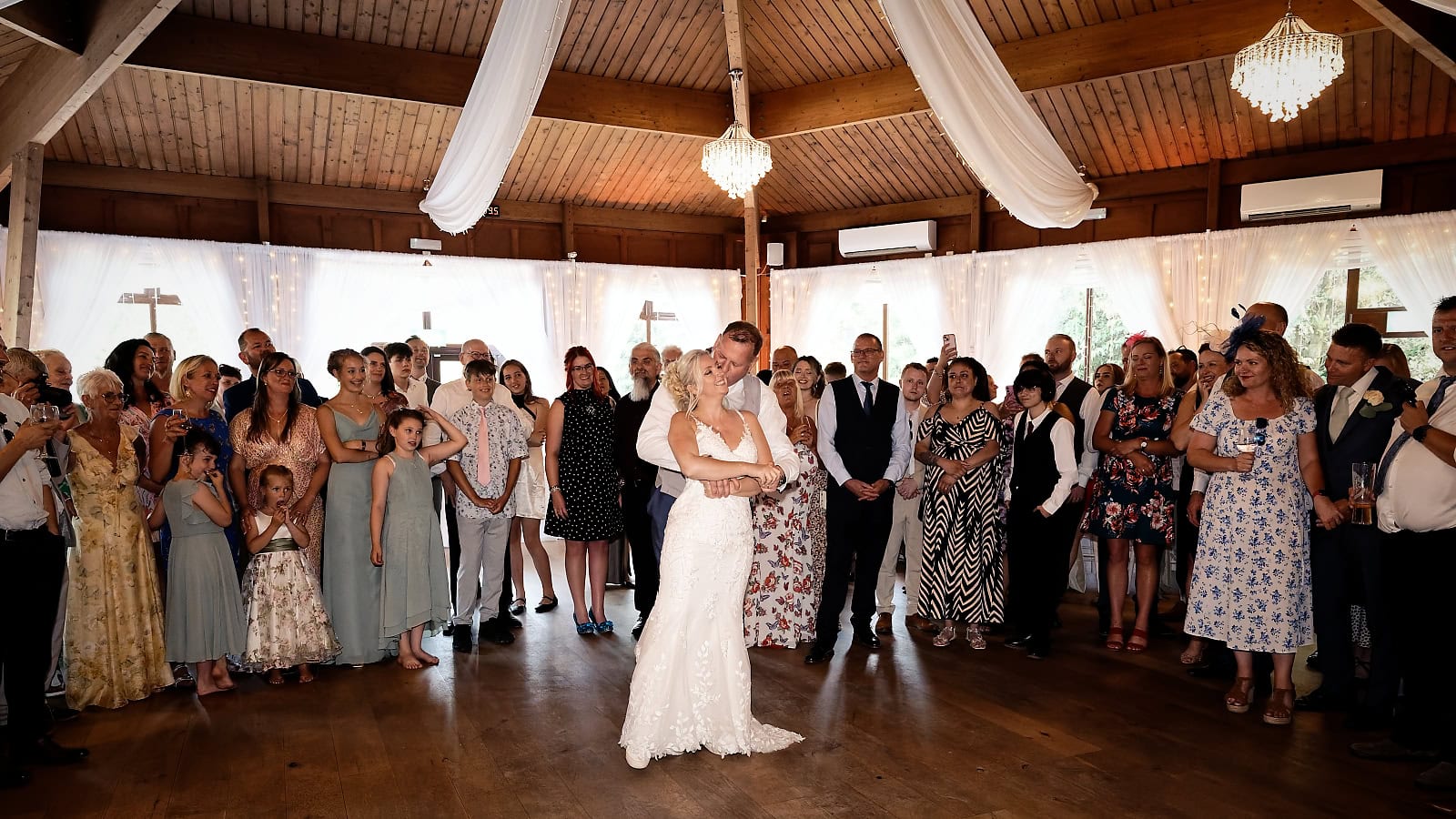 Bride and groom in a close embrace during their first dance at The Ravenswood
