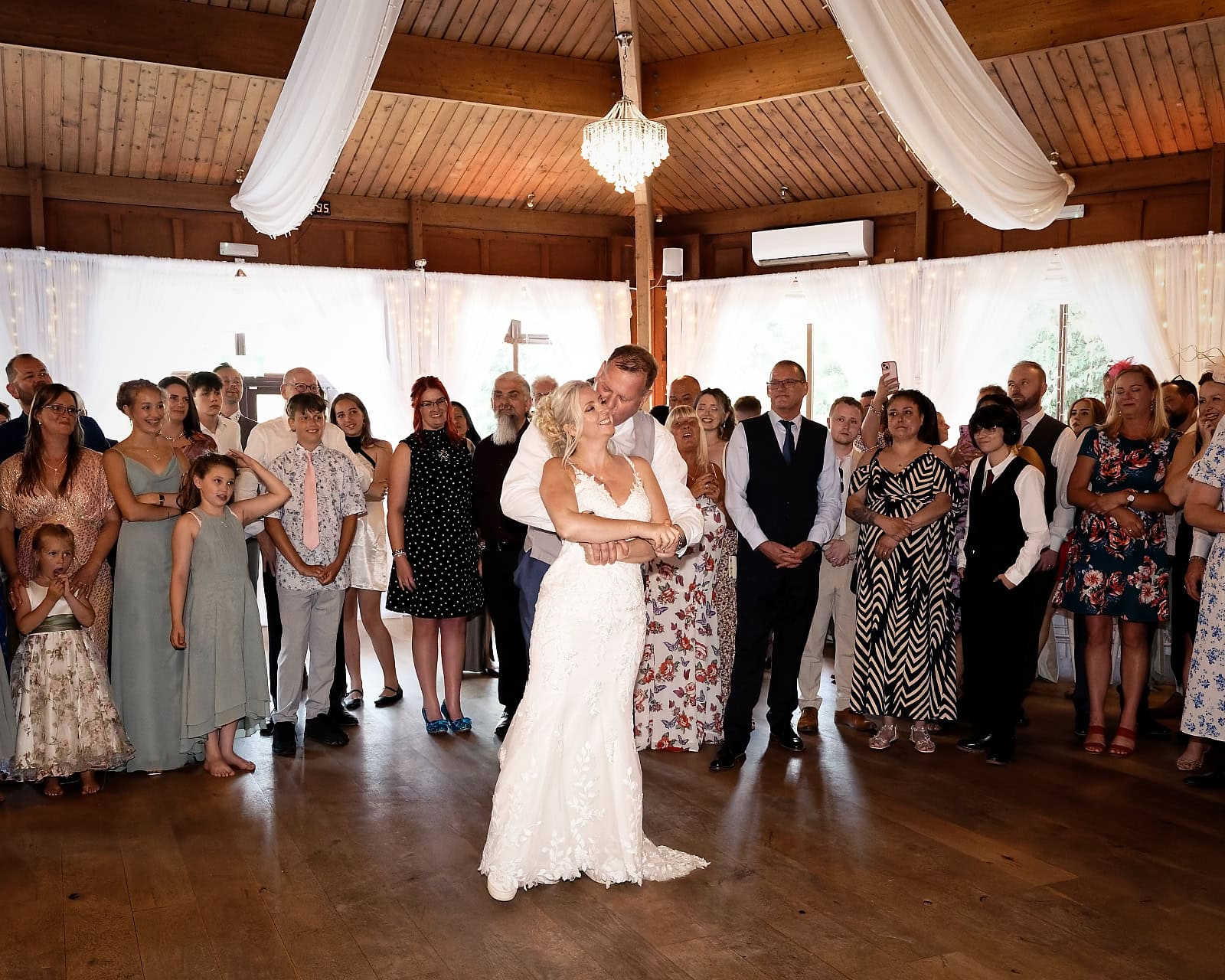 Bride and groom's first dance surrounded by guests at The Ravenswood