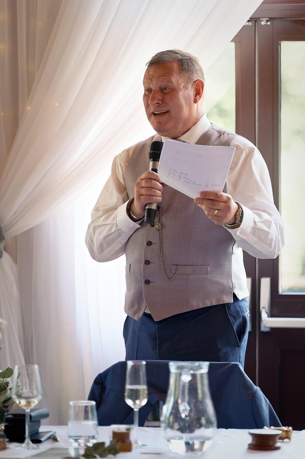 Groom reading his notes during his speech at The Ravenswood