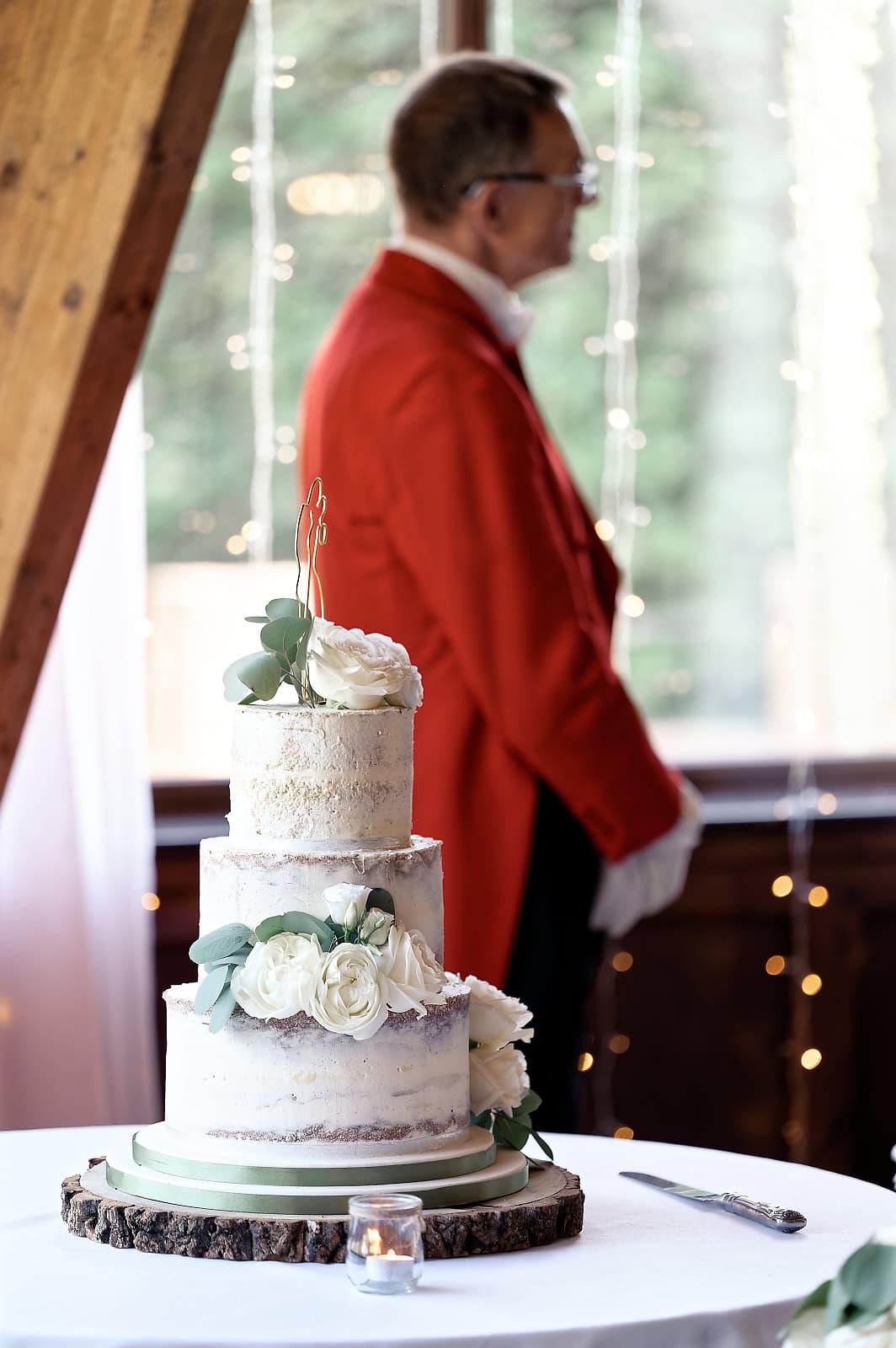 Bride in foreground with groom in the background looking at her | The Ravenswood