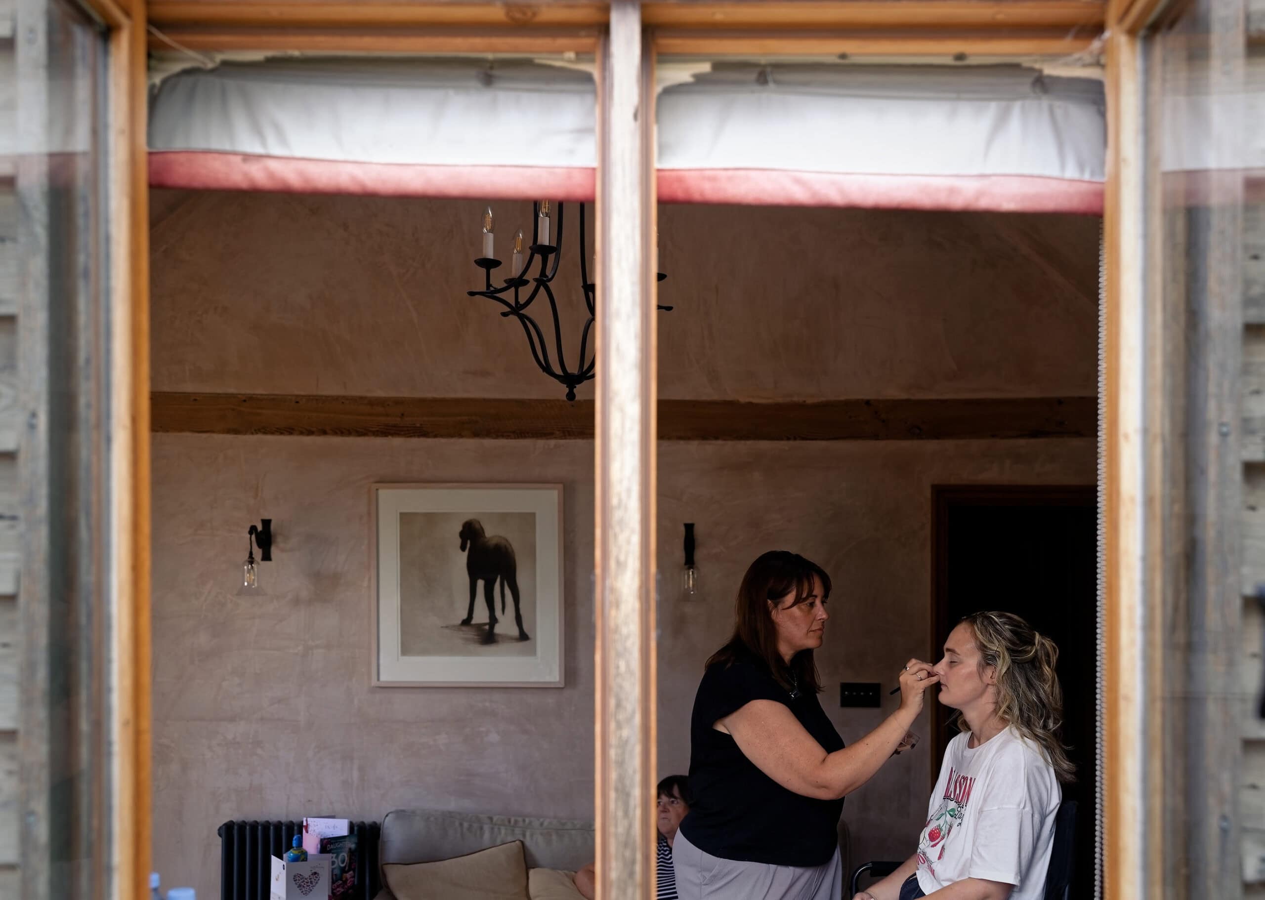 Bride having her makeup done by Gemma Souter during bridal prep at Grittenham Barn