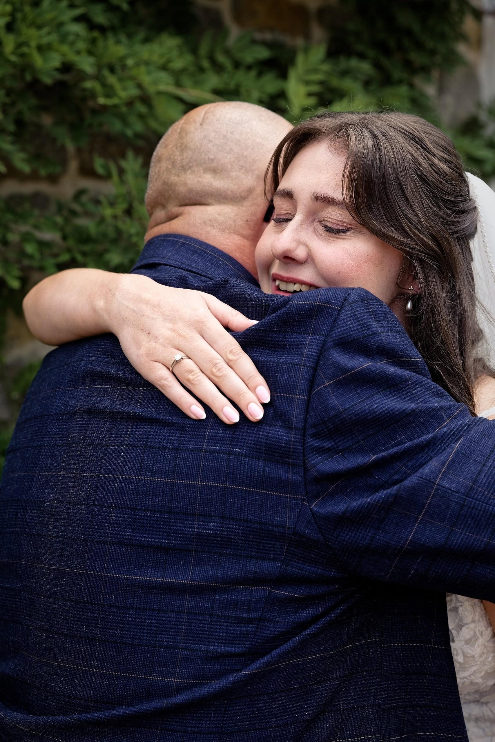 Emotional close up of the bride hugging her dad before the ceremony